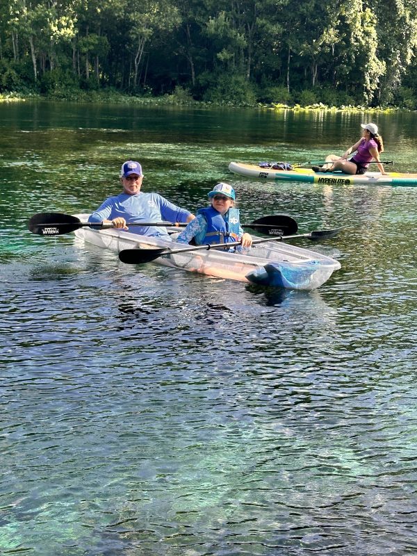 a group of people rowing a boat in the water